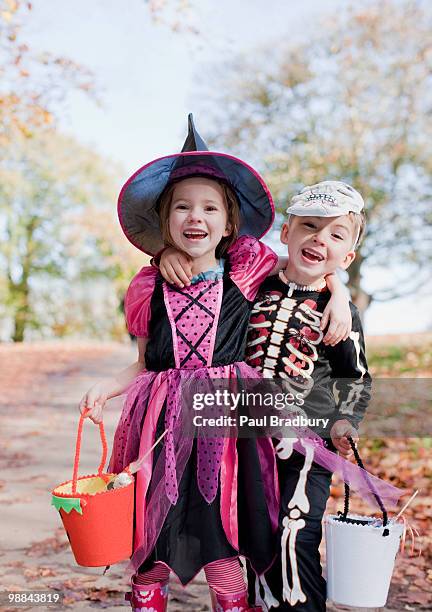 laughing children in halloween costumes - halloween kids stockfoto's en -beelden