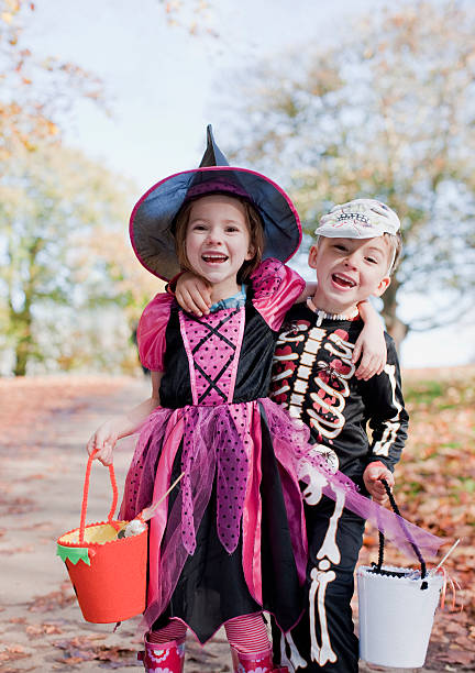 Laughing children in Halloween costumes