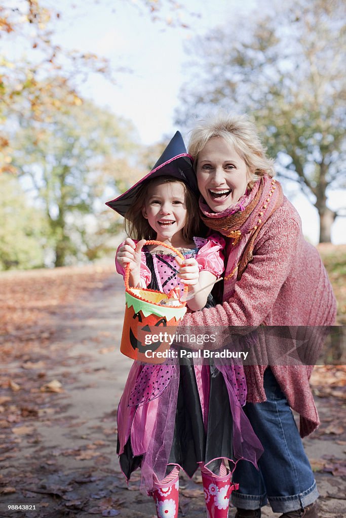 Grandmother hugging granddaughter in Halloween costume