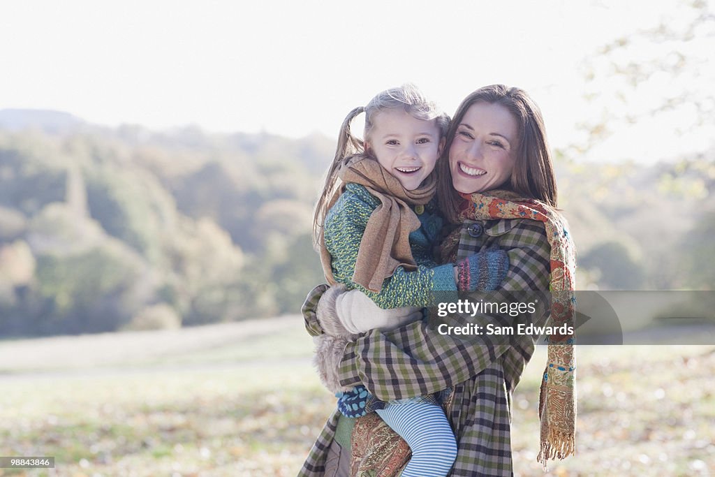 Smiling mother holding daughter