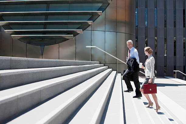 Business people walking up steps