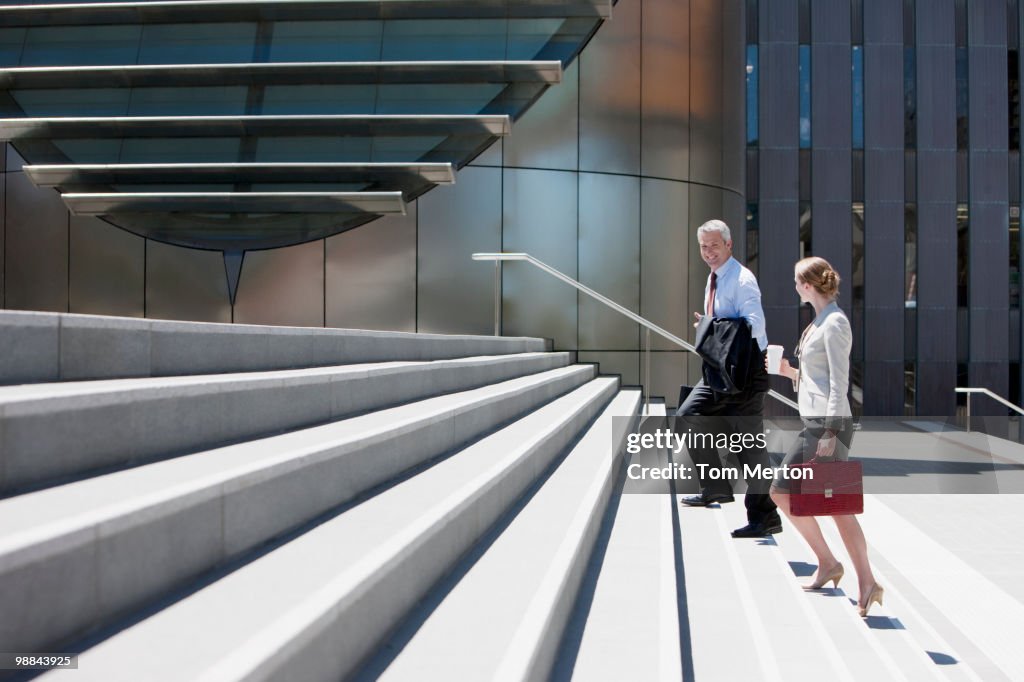 Business people walking up steps