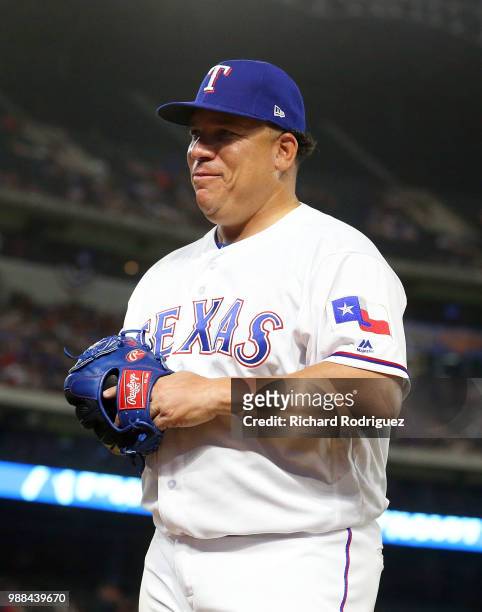 Bartolo Colon of the Texas Rangers walks back to the dugout after being relieved in the sixth inning against the Chicago White Sox at Globe Life Park...