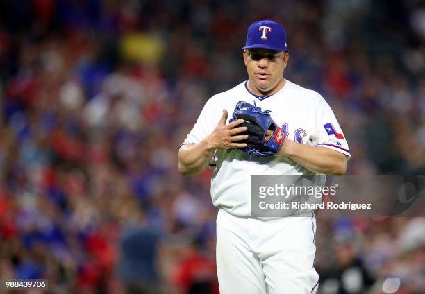 Bartolo Colon of the Texas Rangers walks back to the dugout after being relieved in the sixth inning against the Chicago White Sox at Globe Life Park...