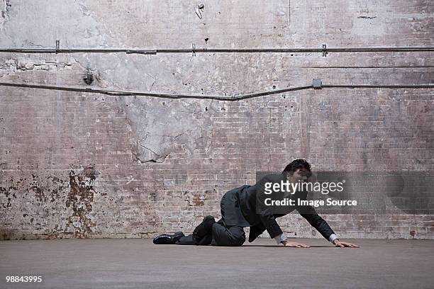 man lying on warehouse floor - crawling bildbanksfoton och bilder