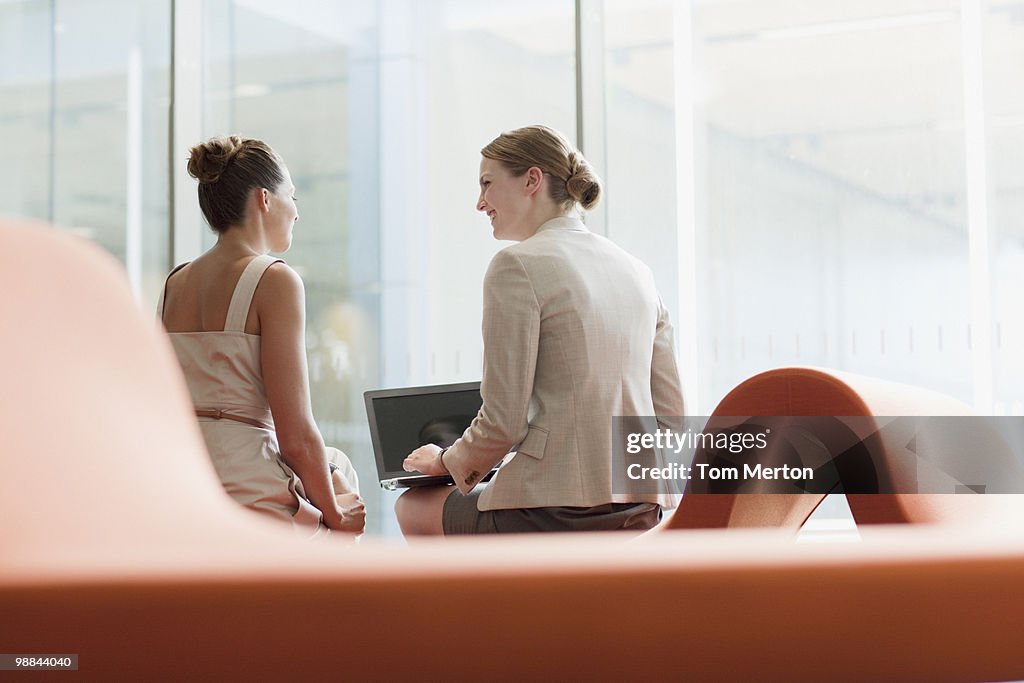 Businesswomen working in waiting area