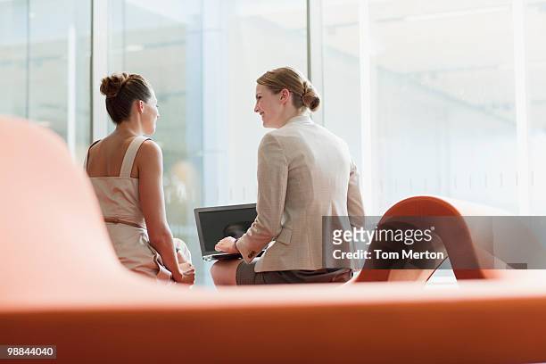 businesswomen working in waiting area - three quarter length stock pictures, royalty-free photos & images