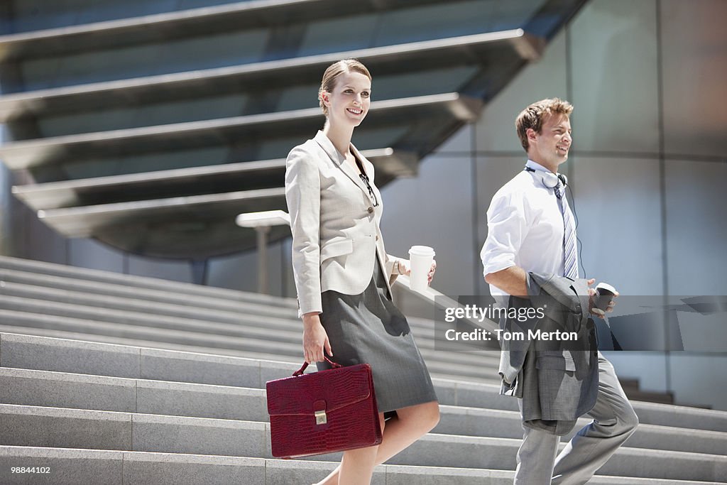 Business people walking down steps outdoors