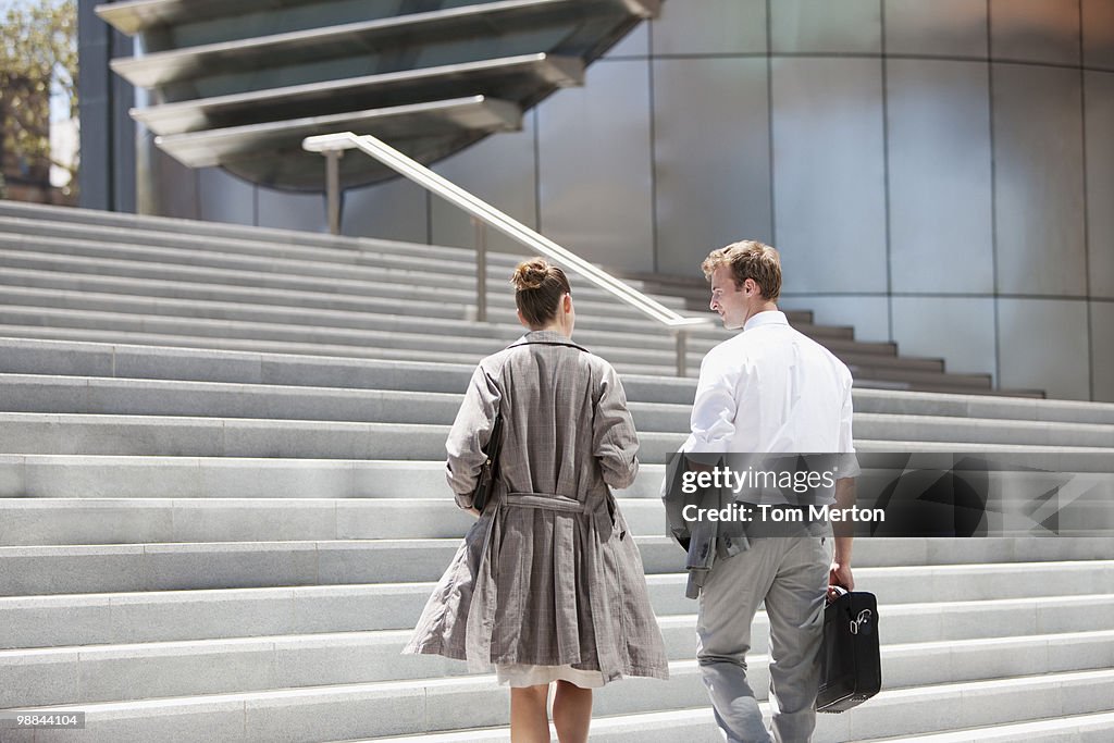 Business people walking toward steps outdoors