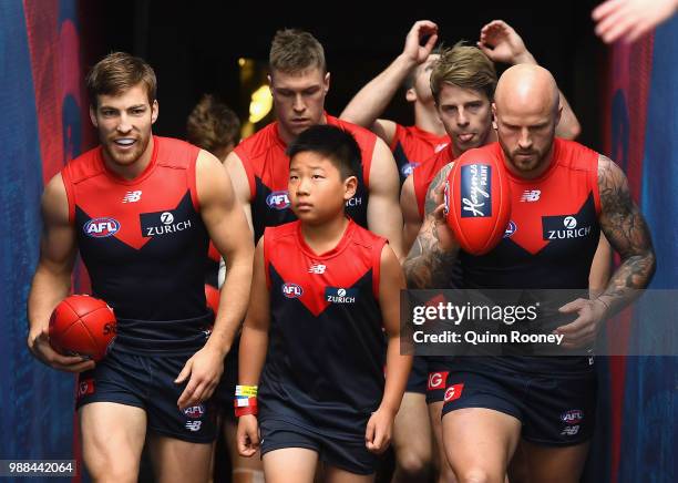 Jack Viney and Nathan Jones of the Demons lead their team out onto the field during the round 15 AFL match between the Melbourne Demons and the St...