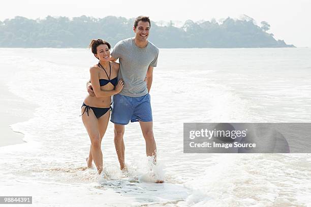 couple walking in the sea - indian honeymoon couples stock pictures, royalty-free photos & images