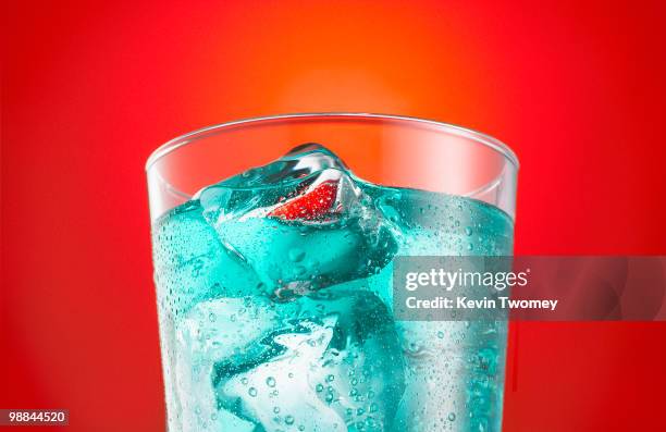 close up of blue soda in glass with ice cubes - glasses condensation stock pictures, royalty-free photos & images