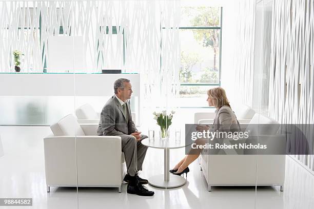 business people having meeting in office lobby - lounge chair bildbanksfoton och bilder