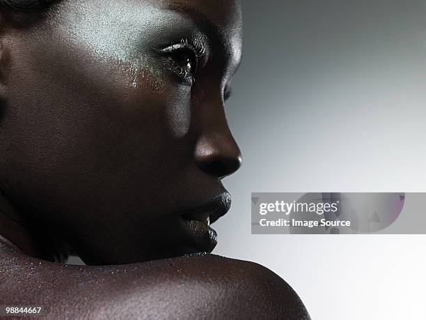 young woman covered in metallic make up - glitter face stock pictures, royalty-free photos & images