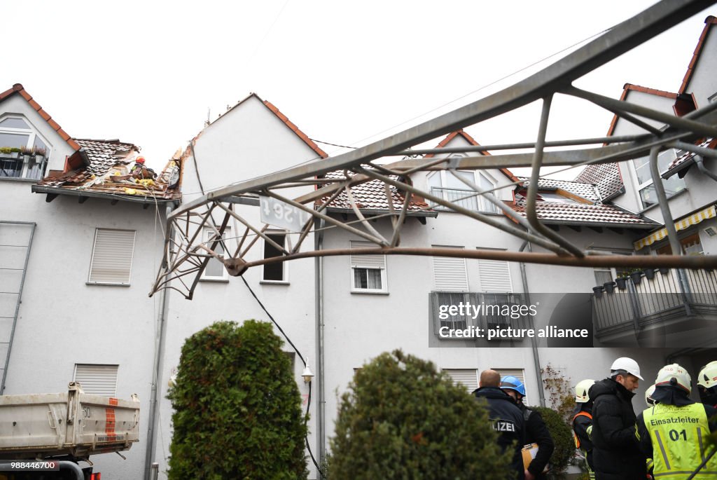 Construction crane falls onto apartment house