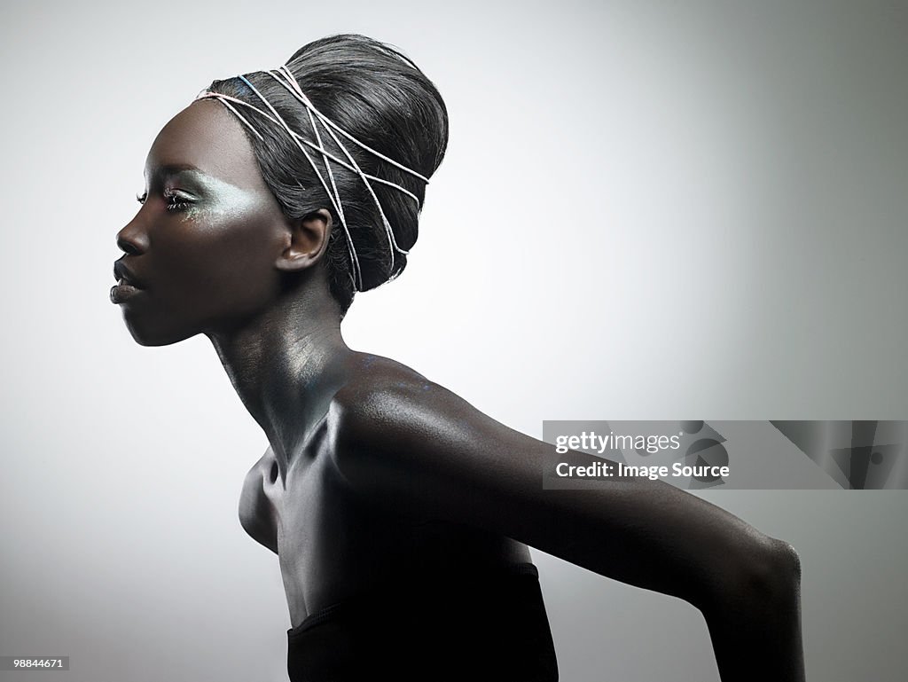 Side view of woman with metallic make up