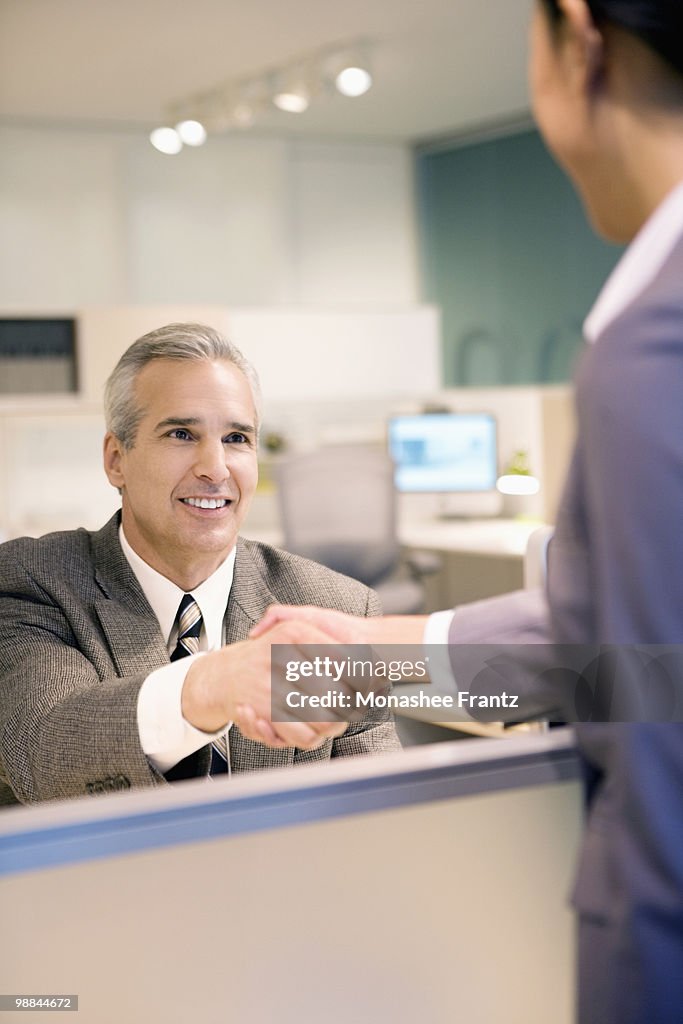 Business people shaking hands in office