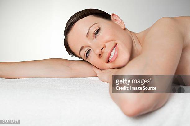 young woman on massage table - massage table white background stock pictures, royalty-free photos & images