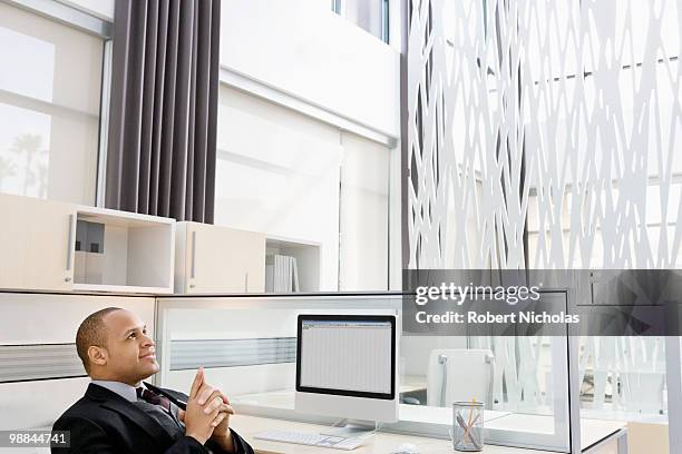 businessman daydreaming at desk in office - robert moreno fotografías e imágenes de stock