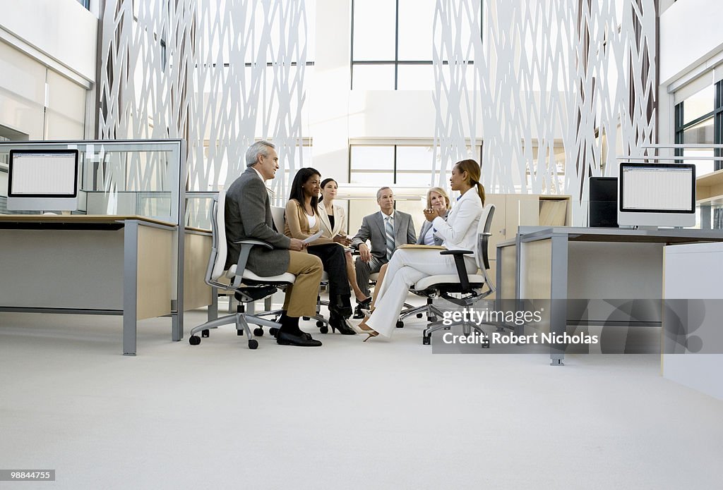 Business people having meeting in middle of office