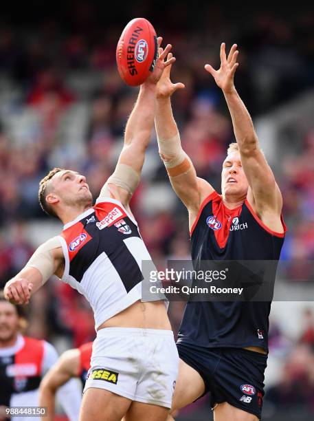 Luke Dunstan of the Saints and Tom McDonald of the Demons compete for a mark during the round 15 AFL match between the Melbourne Demons and the St...