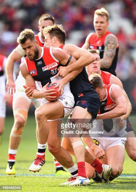 Maverick Weller of the Saints is tackled by Dom Tyson of the Demons during the round 15 AFL match between the Melbourne Demons and the St Kilda...