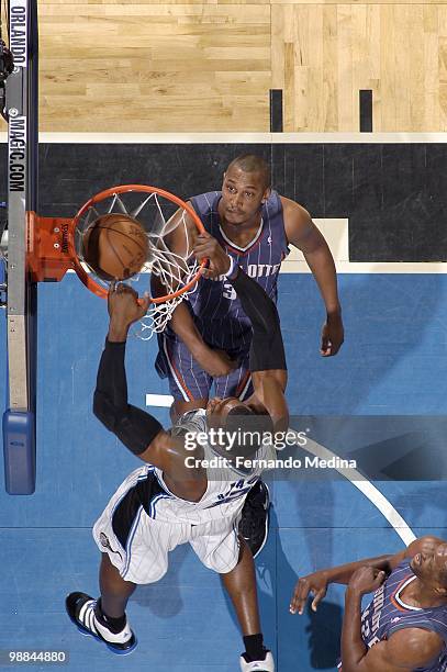 Dwight Howard of the Orlando Magic dunks against Boris Diaw of the Charlotte Bobcats in Game Two of the Eastern Conference Quarterfinals during the...