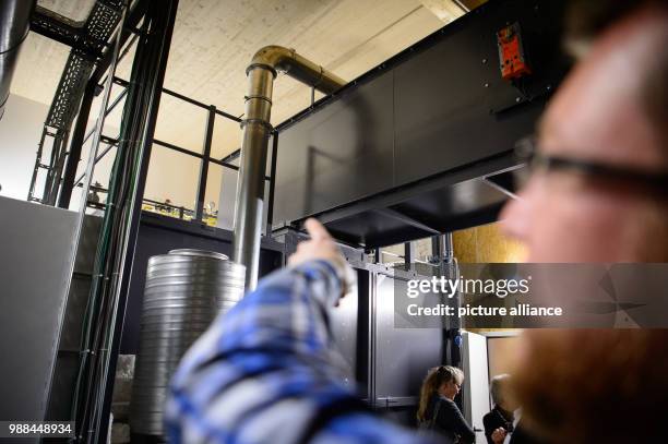 An employee explains the cremation furnace at the nationwide first animal crematory which allows the cremation of horses in Schwaebisch Hall,...