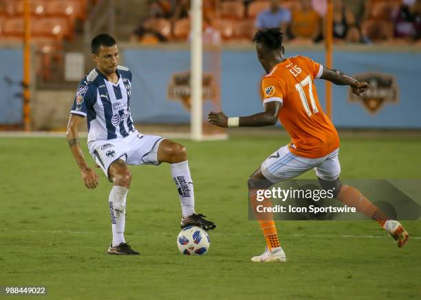 Monterrey defender Leonel Vangioni traps the ball and keeps it away from Houston Dynamo forward Alberth Elis during the BBVA Compass Dynamo Charities...