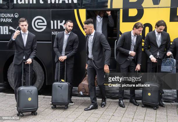 Dortmund's Julian Weigl, Oemer Toprak, Pierre-Emerick Aubameyang, goalkeeper Roman Weidenfeller and Neven Subotic get out of the team bus at the...