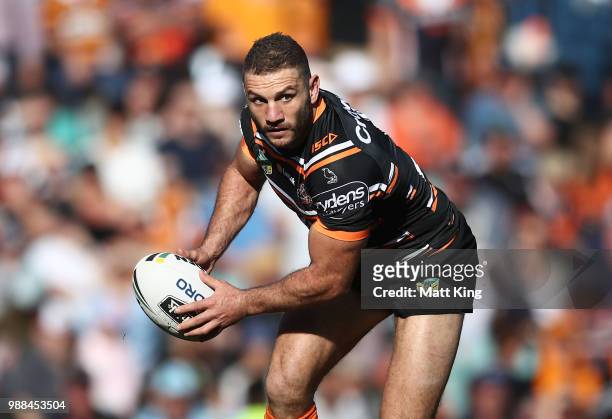 Robbie Farah of the Tigers runs with the ball during the round 16 NRL match between the Wests Tigers and the Gold Coast Titans at Leichhardt Oval on...