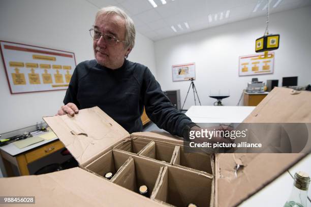The packaging examiner Uwe Moeller opens a package which es previously tested for dropping safety at the package check station of the German Post in...