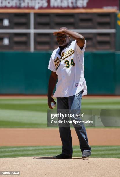 Former Oakland P Dave Stewart jokingly looks to see how far it is to home plate before the MLB game on June 30, 2018 between the Indians and A's at...