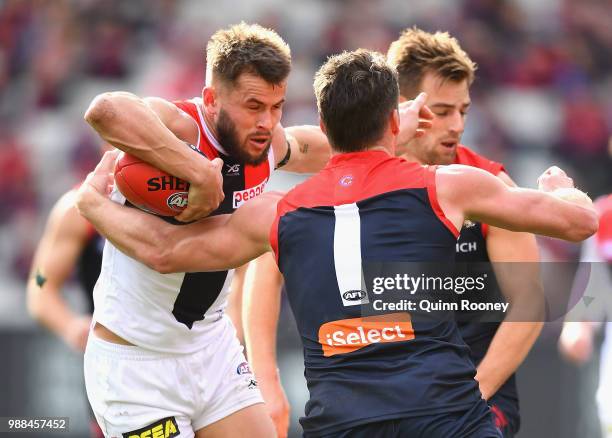 Maverick Weller of the Saints is tackled by Jesse Hogan of the Demons during the round 15 AFL match between the Melbourne Demons and the St Kilda...