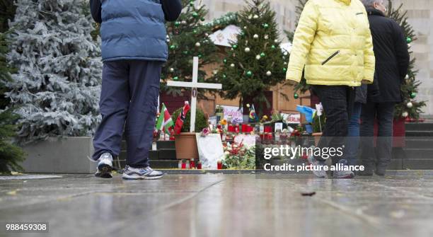 Pedestrians stand at the provisional memorial site for the victims of the 2016 terror attack at the Breitscheidplatz, Germany, 05 December 2017....