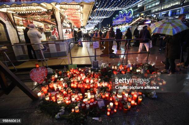 Several candles lie on the ground at the Christmas market at the Berlin Breitscheidplatz in Berlin, Germany, 20 December 2016. Anis Amri is...