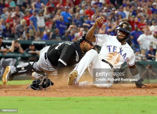 Omar Narvaez of the Chicago White Sox is late with the tag as Delino DeShields of the Texas Rangers scores in the seventh inning of a baseball game...