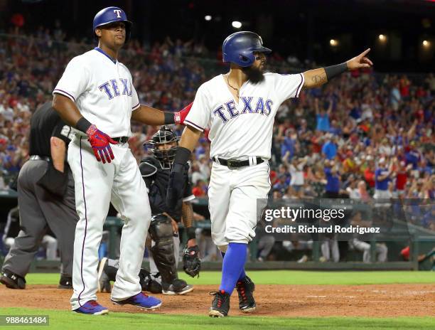 Rougned Odor of the Texas Rangers gestures to Jurickson Profar after he and Adrian Beltre scored on his double in the eighth inning against the...