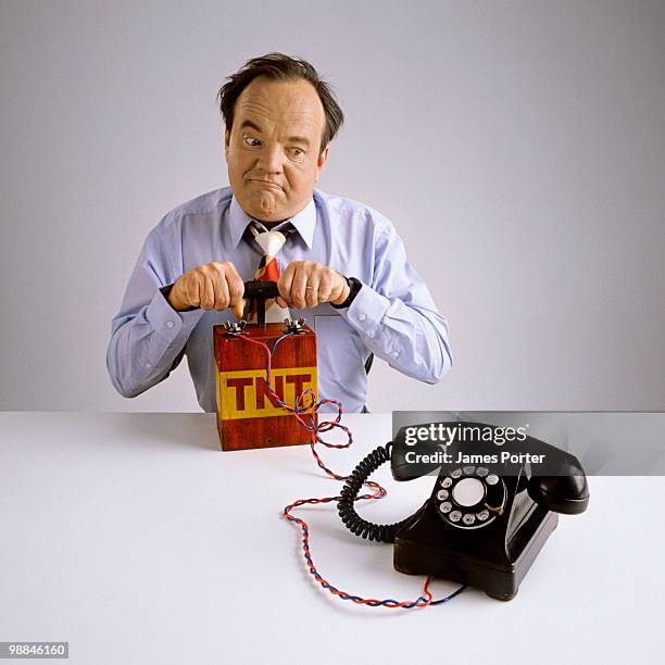 businessman with dynamite and telephone - dynamite stock pictures, royalty-free photos & images