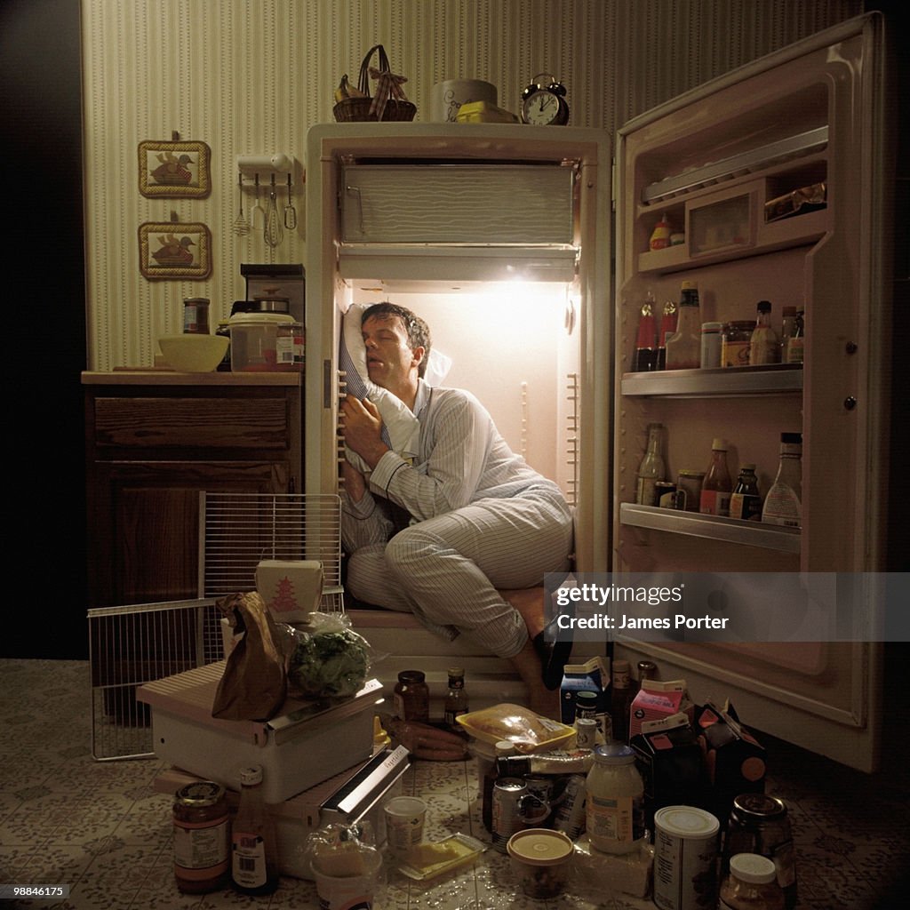 Man sleeping inside refrigerator