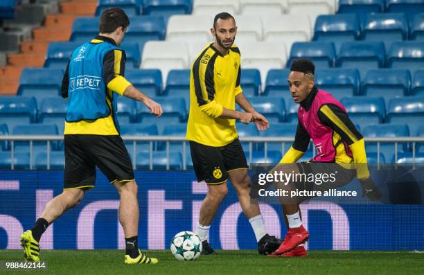 Dortmund's Sokratis, Oemer Toprak and Pierre-Emerick Aubameyang take part in the training of their team at the Estadio Santiago Bernabéu stadium in...