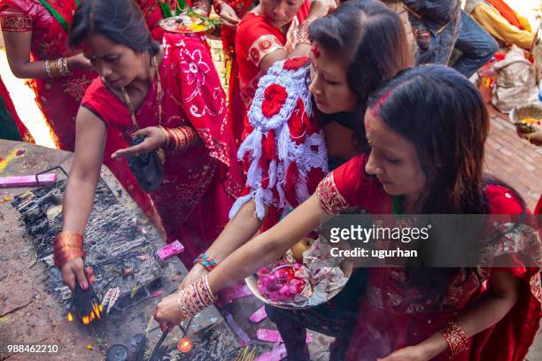 nepalese women clad in red traditional clothing on religious event in temple. - clad stock pictures, royalty-free photos & images