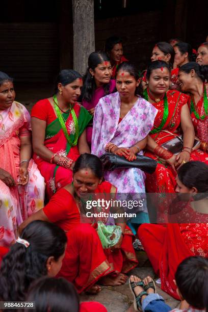 nepalese women clad in red traditional clothing on religious event in temple. - clad stock pictures, royalty-free photos & images