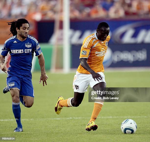 Dominic Oduro of the Houston Dynamo brings the ball up the field against the Kansas City Wizards' Stephane Auvray at Robertson Stadium on May 1, 2010...