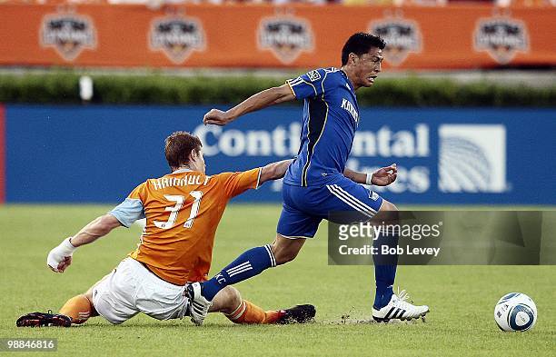 Roger Espinoza of the Kansas City Wizards fends off Andrew Hainult of the Houston Dynamo at Robertson Stadium on May 1, 2010 in Houston, Texas.