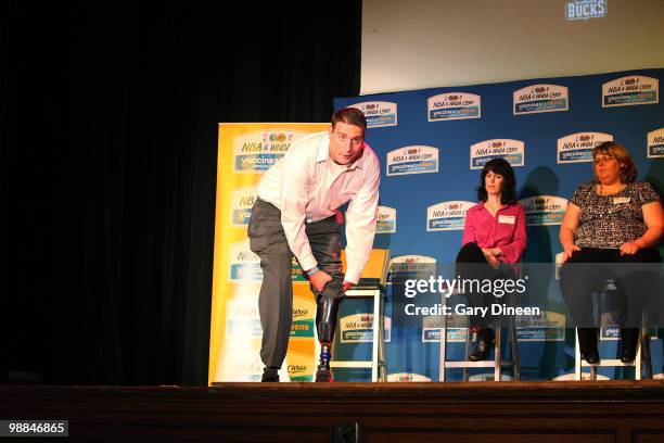 John Kach, meningococcal disease survivor, shows students his prosthetic leg during a Vaccines for Teens event sponsored by NBA Cares and the Society...