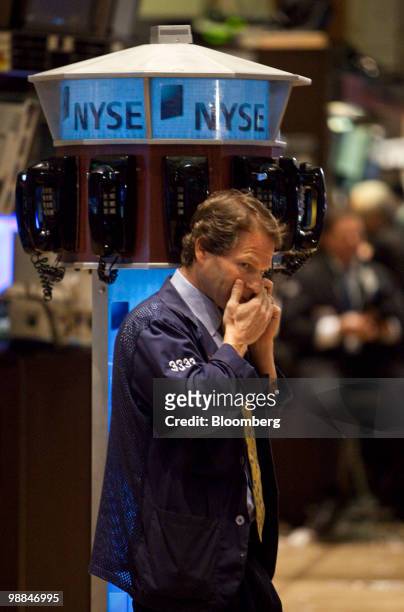 Trader works on the floor of the New York Stock Exchange in New York, U.S., on Tuesday, May 4, 2010. U.S. Equities tumbled the most since February...