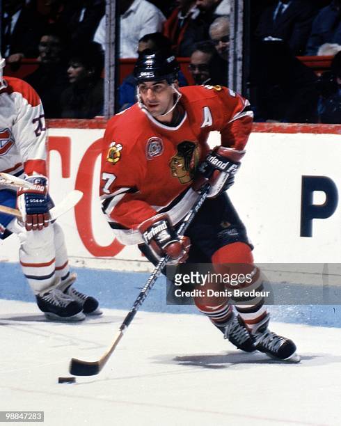 Chris Chelios of the Chicago Black Hawks skates with the puck against the Montreal Canadiens during the early 1990's at the Montreal Forum in...