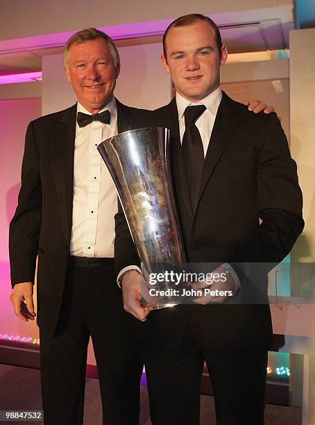 Wayne Rooney of Manchester United is presented with the Players' Player of the Year trophy by Sir Alex Ferguson during the club's annual Player of...