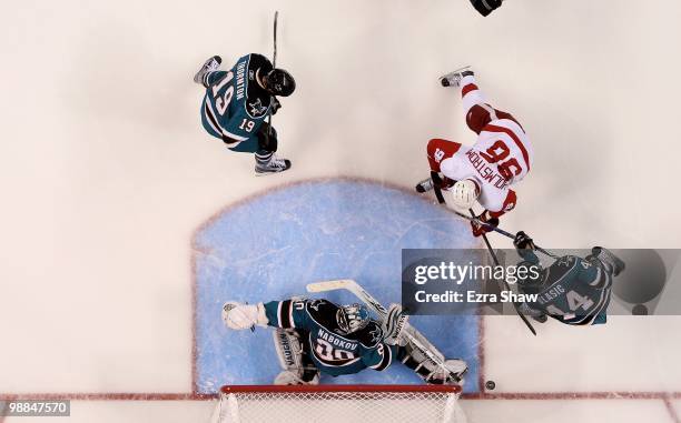 Evgeni Nabokov of the San Jose Sharks plays in the goal while Marc-Edouard Vlasic and Joe Thornton of the Sharks play defense against Tomas Holmstrom...